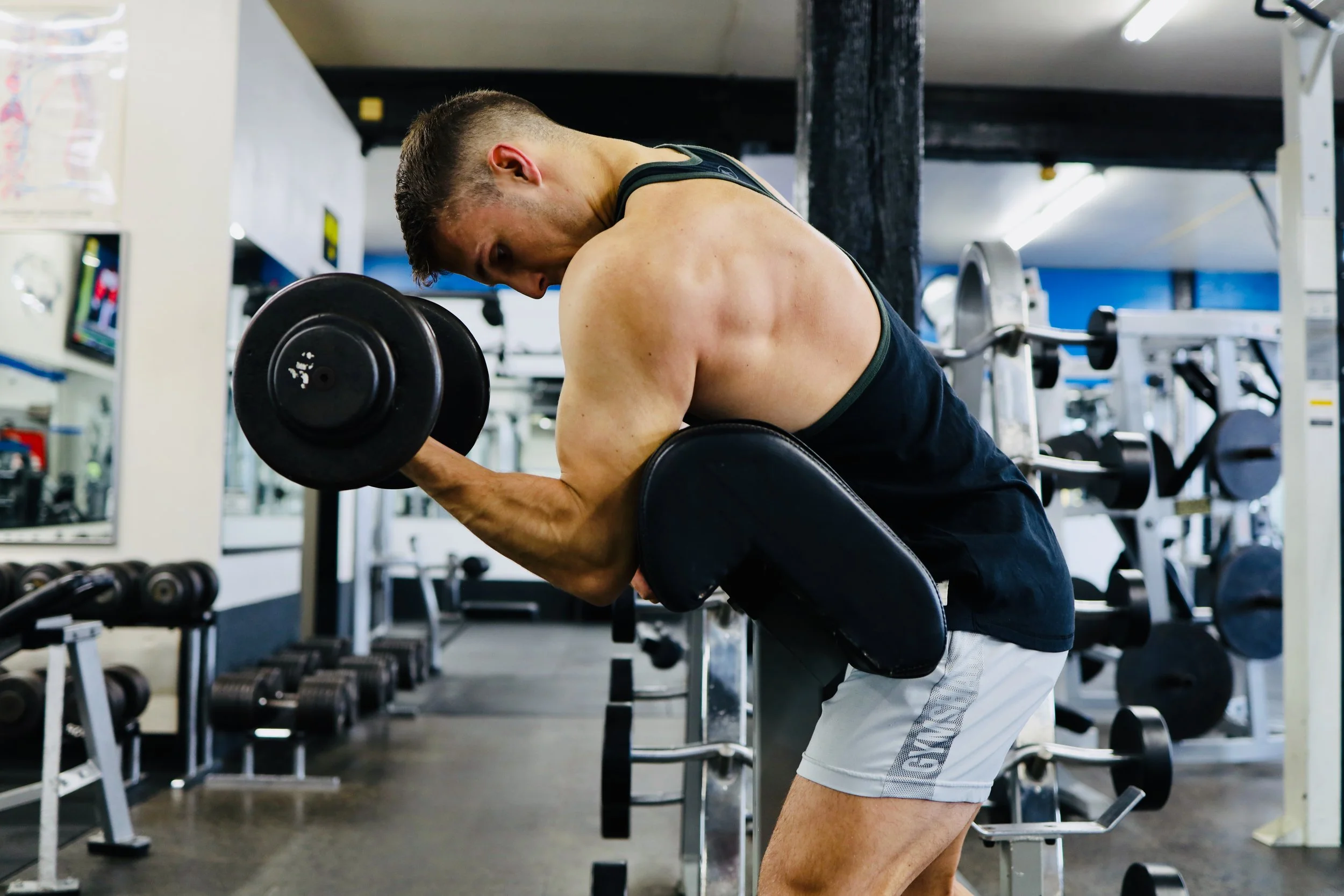 Member performing dumbbell curls