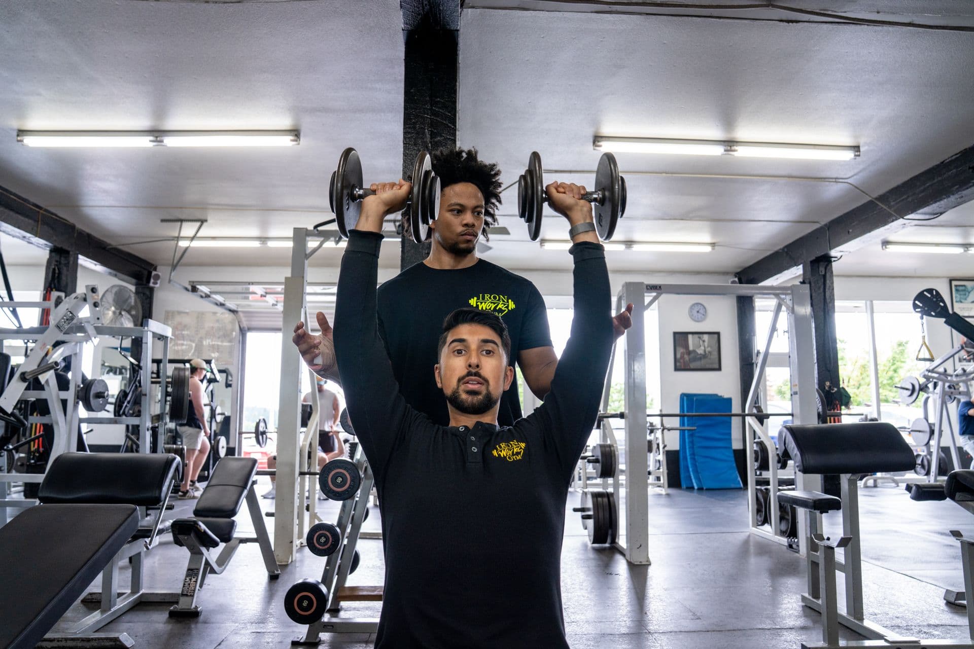 Iron Works Gym trainers coaching and working together